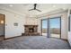 Spacious main bedroom with stone fireplace, and a sliding glass door with outdoor views at 15427 E Firerock Country Club Dr, Fountain Hills, AZ 85268