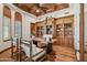 Elegant office with wood paneled ceiling, custom built-in bookshelves and hardwood floors at 15427 E Firerock Country Club Dr, Fountain Hills, AZ 85268