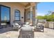 Outdoor patio with multiple seating options, a built-in grill, and stone pillar accents at 15427 E Firerock Country Club Dr, Fountain Hills, AZ 85268