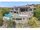 A luxurious home featuring an in-ground pool, spa, and upper and lower outdoor patios at 15427 E Firerock Country Club Dr, Fountain Hills, AZ 85268