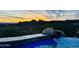 A view from the pool area shows a golden sky, distant mountains, and beautiful desert landscaping at 15427 E Firerock Country Club Dr, Fountain Hills, AZ 85268