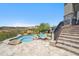 Backyard features a lagoon-style pool and spa, stone stairs, and views of the desert landscape at 15427 E Firerock Country Club Dr, Fountain Hills, AZ 85268