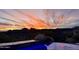 The crystal blue water of the pool beautifully reflects the colors of the sky at sunset at 15427 E Firerock Country Club Dr, Fountain Hills, AZ 85268