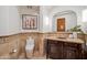 Well-appointed powder room with decorative mirror, travertine floors, and elegant fixtures at 15427 E Firerock Country Club Dr, Fountain Hills, AZ 85268