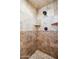 Tiled shower with built-in shelving and a decorative tile border at 15427 E Firerock Country Club Dr, Fountain Hills, AZ 85268
