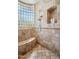 Beautiful walk-in shower with glass block window, tiled surround, and built-in bench at 15427 E Firerock Country Club Dr, Fountain Hills, AZ 85268