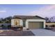 Charming single-story home featuring a neutral color palette, a two-car garage, and a well-kept front yard at 15627 W Hackamore Dr, Surprise, AZ 85387
