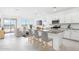 Bright, open-concept kitchen featuring white cabinets, stainless steel appliances, and a granite countertop island at 15627 W Hackamore Dr, Surprise, AZ 85387