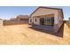 New construction home with backyard awaiting landscaping and a covered patio at 15642 W Georgia Dr, Surprise, AZ 85379