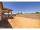 New construction home with backyard awaiting landscaping and a covered patio at 15642 W Georgia Dr, Surprise, AZ 85379
