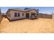 New construction home with backyard awaiting landscaping and a covered patio at 15642 W Georgia Dr, Surprise, AZ 85379