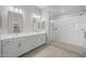 Bright bathroom features a double vanity with modern fixtures and a spacious glass-enclosed shower for relaxing comfort at 15642 W Georgia Dr, Surprise, AZ 85379