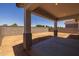 Covered patio with concrete floor and view of yard and block fence at 15642 W Georgia Dr, Surprise, AZ 85379