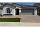 Charming single-story home with a two-car garage and well-manicured front lawn at 15642 W Georgia Dr, Surprise, AZ 85379