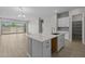 Open-concept kitchen featuring an island with a sink and tile floors at 15642 W Georgia Dr, Surprise, AZ 85379