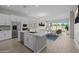 Modern kitchen with an island, stainless steel appliances, and open layout to the dining area at 15642 W Georgia Dr, Surprise, AZ 85379