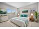 Stylishly decorated main bedroom with a serene color palette, comfortable bed, and plenty of natural light at 15642 W Georgia Dr, Surprise, AZ 85379