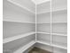 Spacious walk-in pantry with floor-to-ceiling white shelving for organized storage at 15642 W Georgia Dr, Surprise, AZ 85379