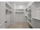 Well-organized walk-in closet with built-in shelving and racks, and carpeted flooring at 15642 W Georgia Dr, Surprise, AZ 85379