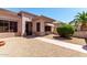 Single-story home showcasing a desert landscape with a small covered entryway, window awnings, and neutral stucco at 16240 W Talara Way, Surprise, AZ 85374
