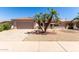 Charming single-story home featuring a well-manicured desert landscape, a two-car garage, and a tiled roof at 16240 W Talara Way, Surprise, AZ 85374