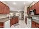 Bright kitchen featuring wood cabinets, granite countertops, a white stove, and views of the outdoor patio at 16240 W Talara Way, Surprise, AZ 85374