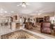 Spacious living room with an open floor plan, multiple ceiling fans, and views into the dining area at 16240 W Talara Way, Surprise, AZ 85374