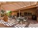 Relaxing outdoor patio covered by a pergola with stylish patio furniture for seating and shade at 16240 W Talara Way, Surprise, AZ 85374