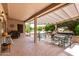 Inviting covered patio featuring multiple seating areas, perfect for outdoor entertaining and relaxation at 16240 W Talara Way, Surprise, AZ 85374