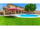 Beautiful backyard showcasing a refreshing pool, a covered patio, and lush green grass perfect for outdoor enjoyment at 16245 W Papago St, Goodyear, AZ 85338