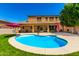 Inviting backyard featuring a sparkling pool, covered patio, and manicured lawn, ideal for relaxation and entertainment at 16245 W Papago St, Goodyear, AZ 85338