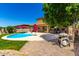 Backyard with a pool, patio furniture, a grill, and landscaped features, perfect for outdoor living at 16245 W Papago St, Goodyear, AZ 85338