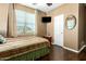 Comfortable bedroom features hardwood floors, a large window, and neutral paint at 16245 W Papago St, Goodyear, AZ 85338