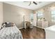 Cozy bedroom with hardwood floors, a desk by the window, and neutral-colored walls at 16245 W Papago St, Goodyear, AZ 85338