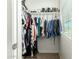 Bright walk-in closet with hanging clothes and shoe rack near a window, maximizing storage space at 16245 W Papago St, Goodyear, AZ 85338