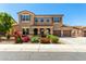 Two-story home features a three-car garage, arched entryway, and desert landscaping at 16245 W Papago St, Goodyear, AZ 85338