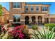 Two-story home with arched entryway, desert landscaping, and a three-car garage at 16245 W Papago St, Goodyear, AZ 85338