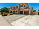 Spacious two-story home featuring a three-car garage and long driveway at 16245 W Papago St, Goodyear, AZ 85338
