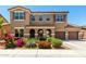 Two-story home features a three-car garage, arched entryway, and desert landscaping at 16245 W Papago St, Goodyear, AZ 85338
