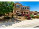 Two-story home featuring drought-resistant landscaping, arched entryway, and a three-car garage at 16245 W Papago St, Goodyear, AZ 85338