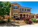 Two-story home featuring drought-resistant landscaping, arched entryway, and a three-car garage at 16245 W Papago St, Goodyear, AZ 85338