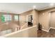 Bright hallway featuring wood floors, neutral paint, and an open view of the staircase and windows at 16245 W Papago St, Goodyear, AZ 85338