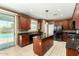 Bright kitchen with an island, stainless steel appliances, and access to the pool area at 16245 W Papago St, Goodyear, AZ 85338