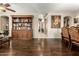 Open living room with hardwood floors and a custom built-in bookcase at 16245 W Papago St, Goodyear, AZ 85338