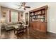 Living room with hardwood floors, and a custom built-in bookcase at 16245 W Papago St, Goodyear, AZ 85338
