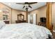 Bedroom featuring a decorative bed frame, wood floors, and an ensuite bathroom at 16245 W Papago St, Goodyear, AZ 85338