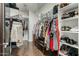 Spacious walk-in closet with custom shelving, hanging rods, and wood floors at 16245 W Papago St, Goodyear, AZ 85338