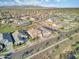 Aerial view of a neighborhood of homes with desert landscaping on a partly cloudy day with mountains in the distance at 18381 W La Senda Dr, Surprise, AZ 85387