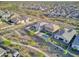 Aerial view of a neighborhood of homes including pools, backyard grass and desert landscaping on a partly cloudy day at 18381 W La Senda Dr, Surprise, AZ 85387