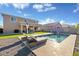 Backyard featuring a sparkling swimming pool, patio furniture, and turf at 18381 W La Senda Dr, Surprise, AZ 85387